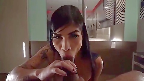 A brunette with tattooed boobs gets fucked deepthroat